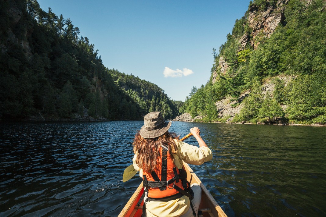 Traveller paddling through a scenic canyon