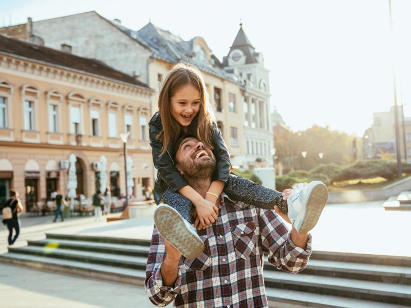 Father and daughter exploring a city abroad